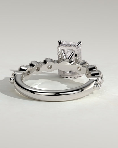 Josephine - Radiant Claw Solitaire with Round Accent Stones and Wrap Around Hidden Halo Engagement Ring - White Gold
