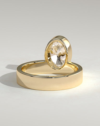 Carmen - Oval Bezel Solitaire with Offset Setting and Flat Cigar Band Engagement Ring - Yellow Gold