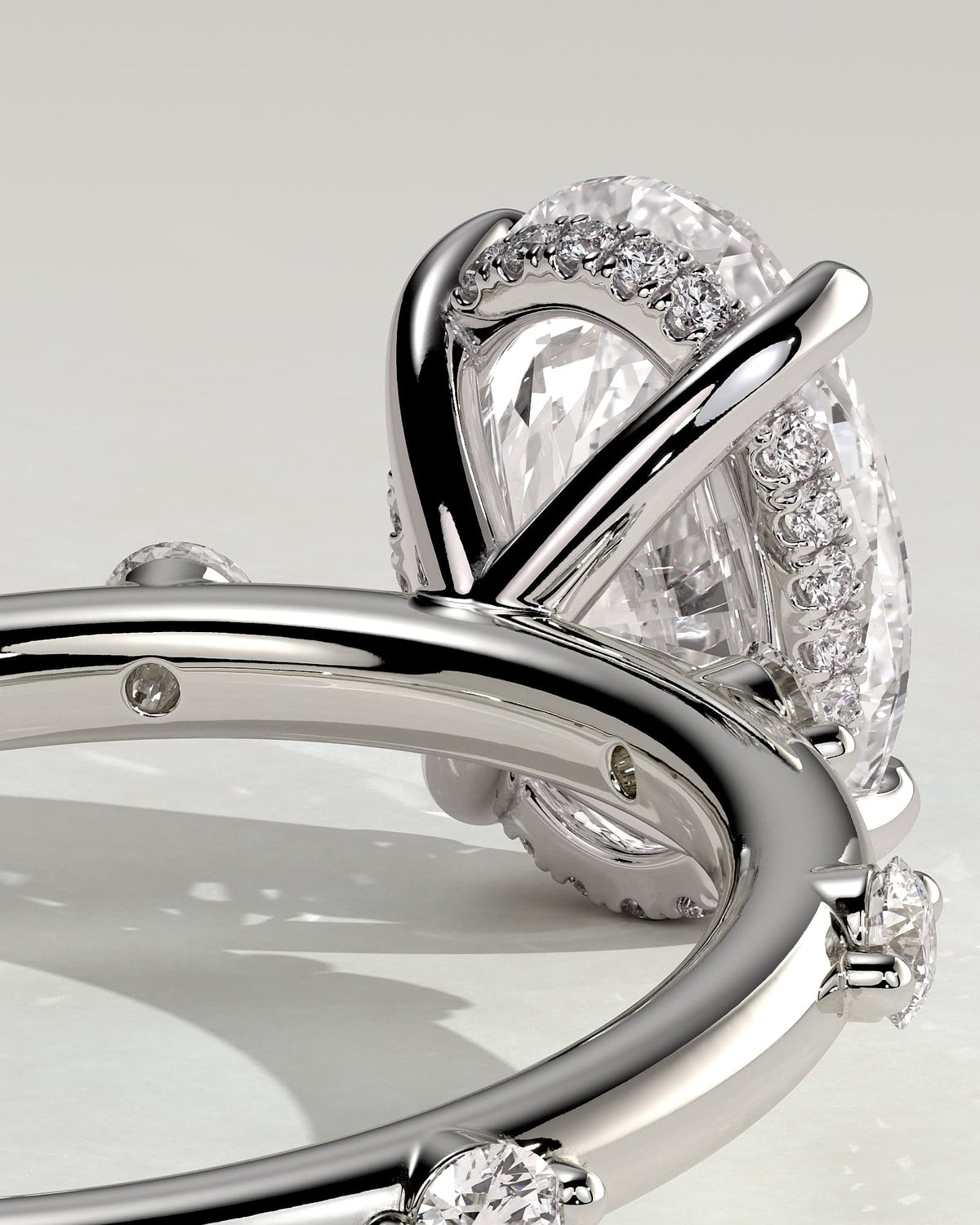 Elise - Oval Claw Solitaire with 6 Spaced Round Accent Stones and Hidden Halo Engagement Ring - White Gold