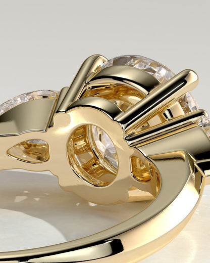 Halle - Round Claw Trilogy with Pear Side Stones and Knife Edge Band Engagement Ring - Yellow Gold