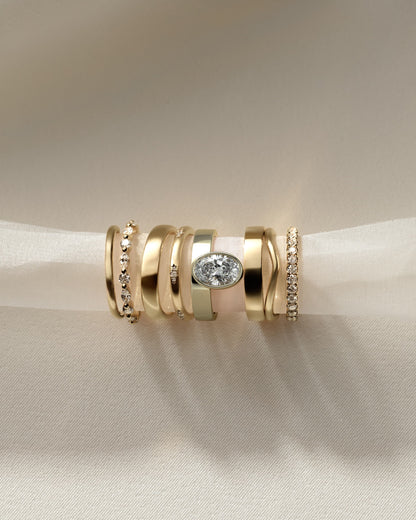 Carmen - Oval Bezel Solitaire with Offset Setting and Flat Cigar Band Engagement Ring - Yellow Gold