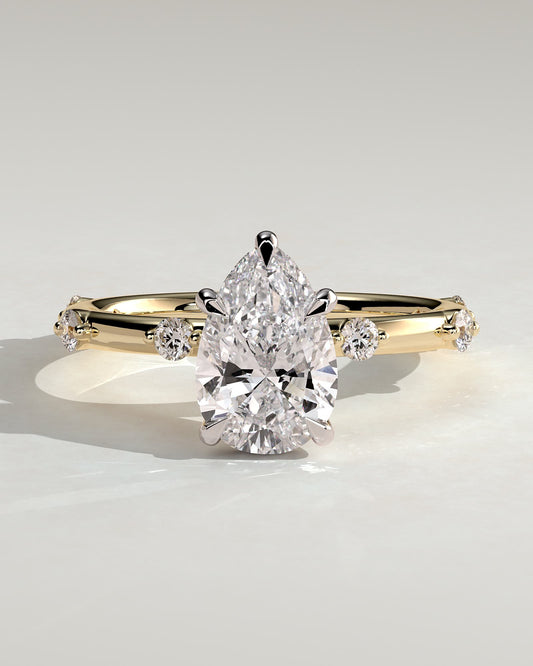 Amora - Pear Claw Solitaire with 6 Spaced Round Accent Stones and Hidden Halo Engagement Ring - Yellow Two-Tone