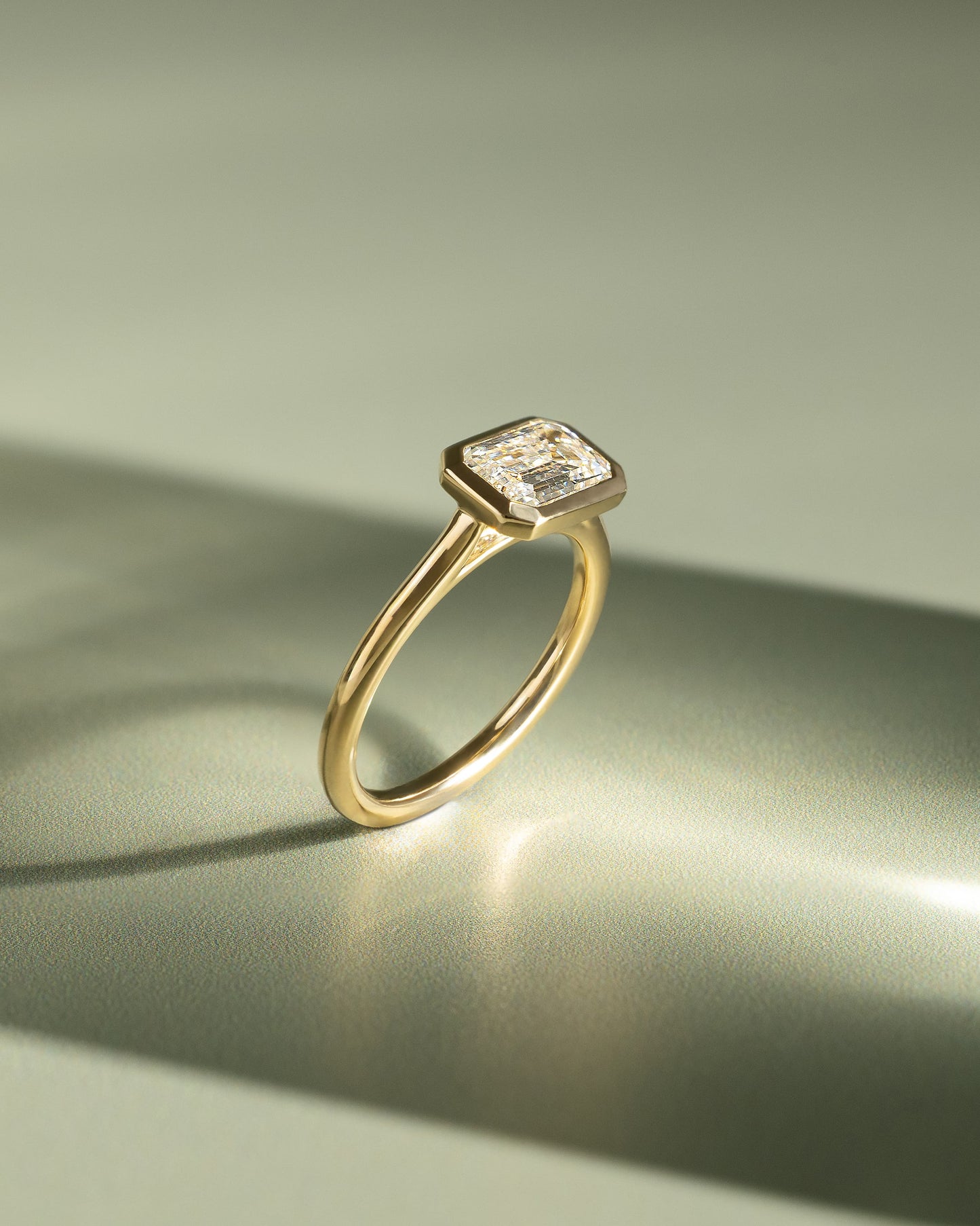 Olive - Statement Emerald East West Bezel Solitaire with Open Cathedral High Setting Engagement Ring - Yellow Gold