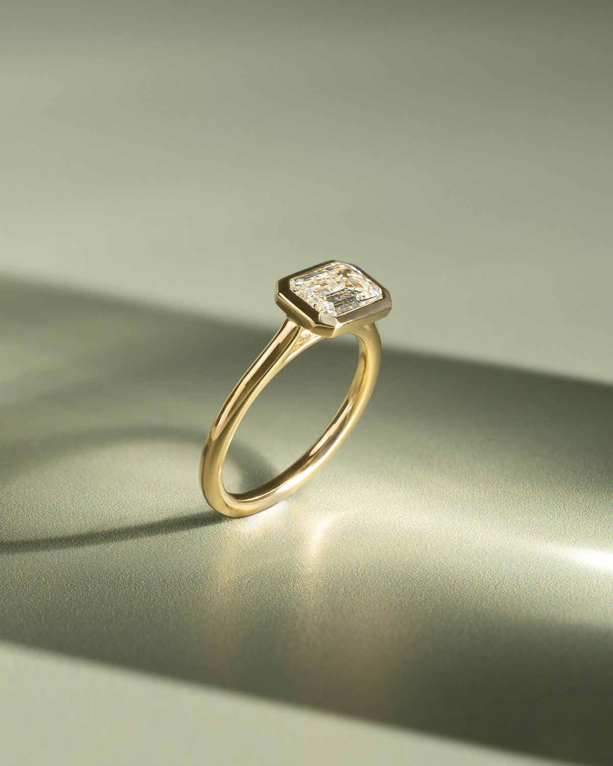 Olive - Statement Emerald East West Bezel Solitaire with Open Cathedral High Setting Engagement Ring - White Gold