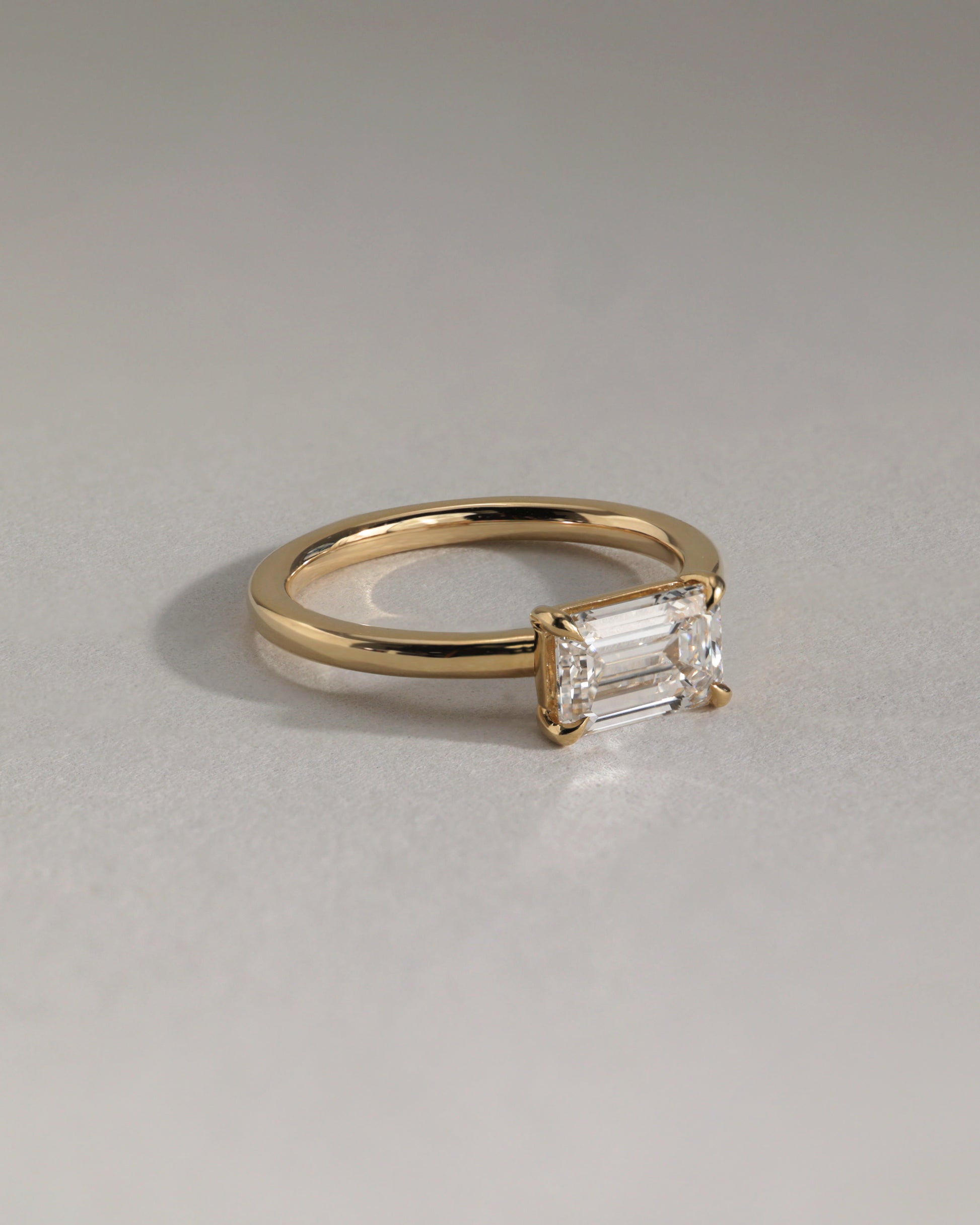 Evelyn - Emerald East West Claw Solitaire with Raised Basket Gallery Engagement Ring - Platinum - Lifestyle