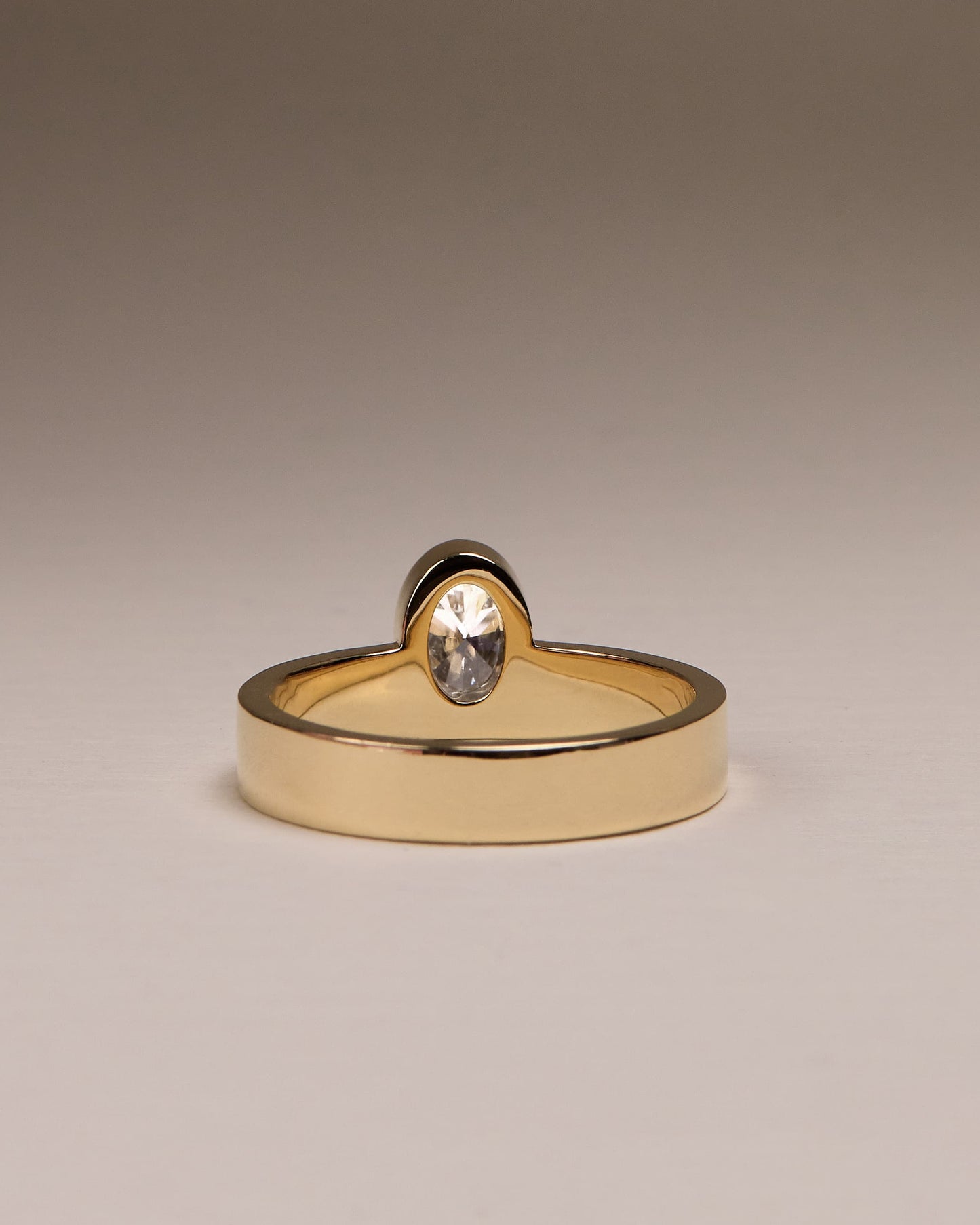 Carmen - Oval Bezel Solitaire with Offset Setting and Flat Cigar Band Engagement Ring - Yellow Gold