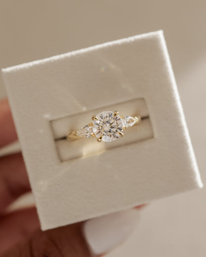 Halle - Round Claw Trilogy with Pear Side Stones and Knife Edge Band Engagement Ring - Yellow Gold