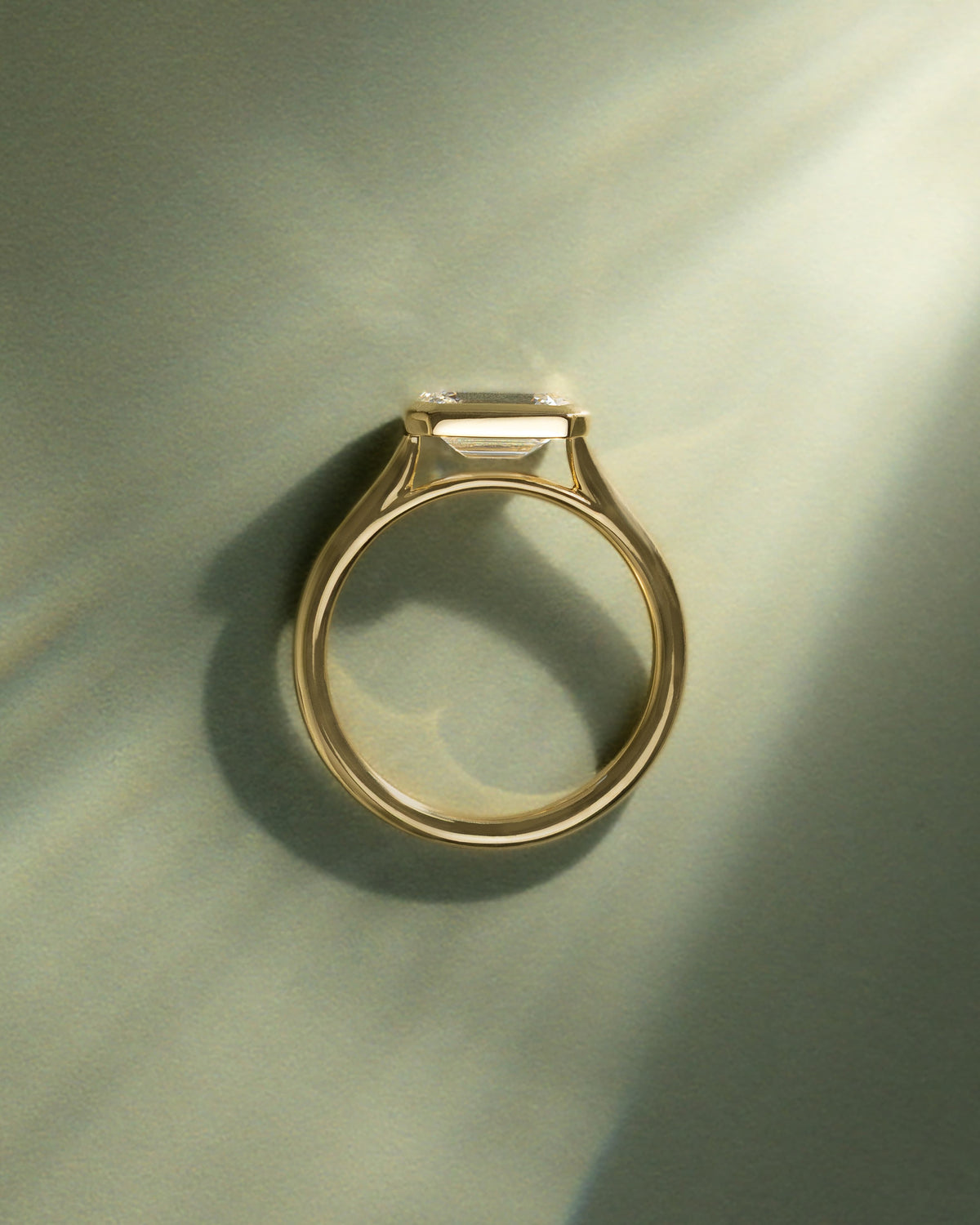 Olive - Statement Emerald East West Bezel Solitaire with Open Cathedral High Setting Engagement Ring - Yellow Gold