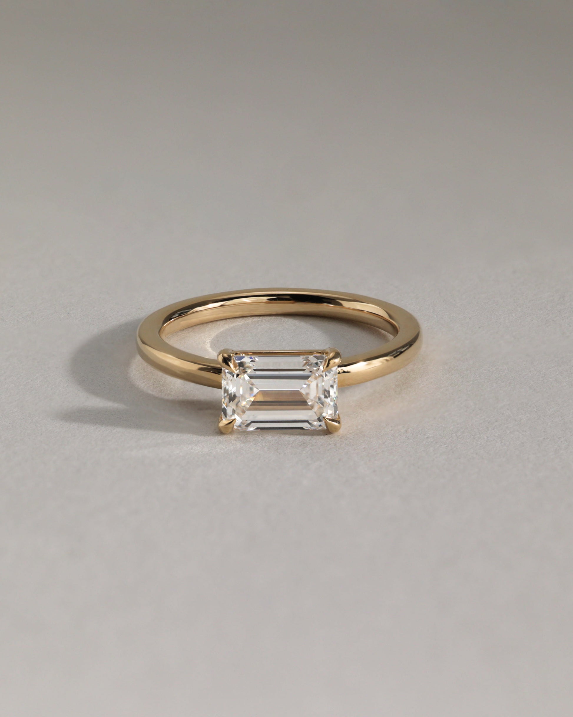 Evelyn - Emerald East West Claw Solitaire with Raised Basket Gallery Engagement Ring - Platinum - Lifestyle