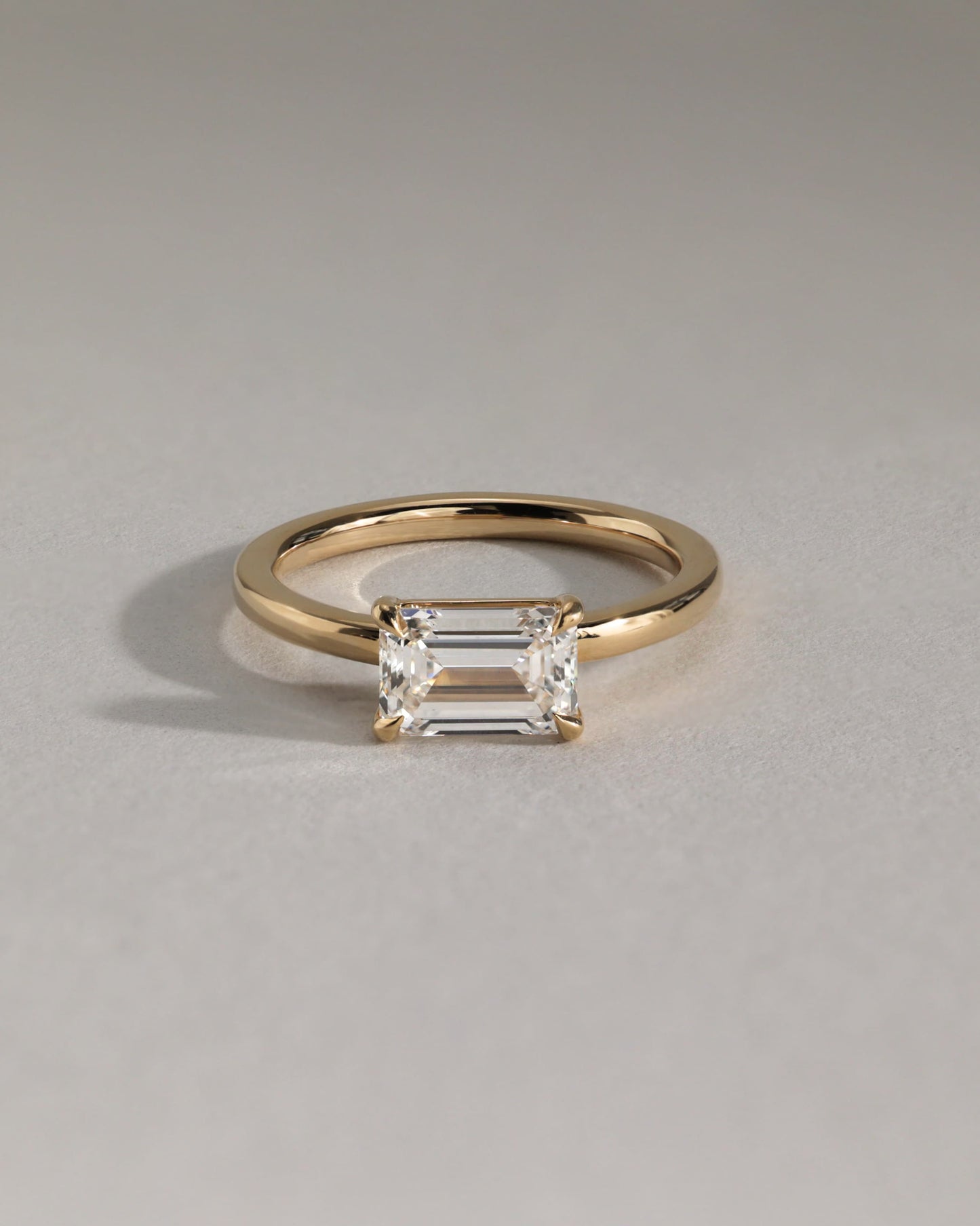 Evelyn - Emerald East West Claw Solitaire with Raised Basket Gallery Engagement Ring - Yellow Gold