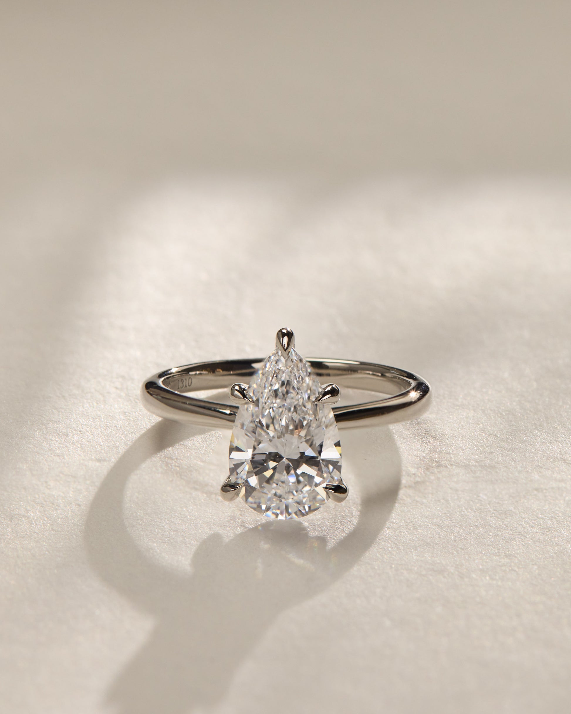 Aspen - Pear Claw Solitaire with Pinched Tapered Band and Cathedral Low Setting Engagement Ring - Platinum - Lifestyle