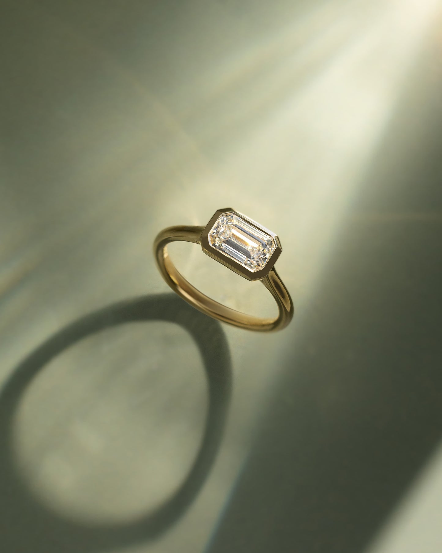 Olive - Statement Emerald East West Bezel Solitaire with Open Cathedral High Setting Engagement Ring - Platinum