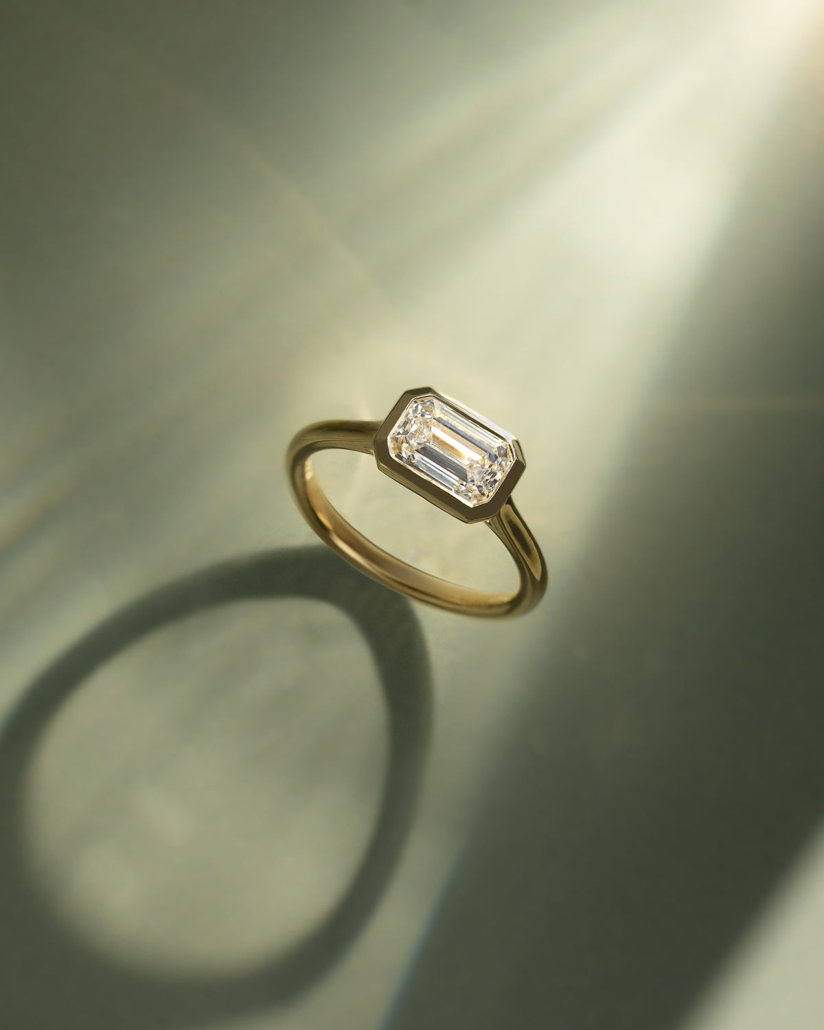 Olive - Statement Emerald East West Bezel Solitaire with Open Cathedral High Setting Engagement Ring - Yellow Gold