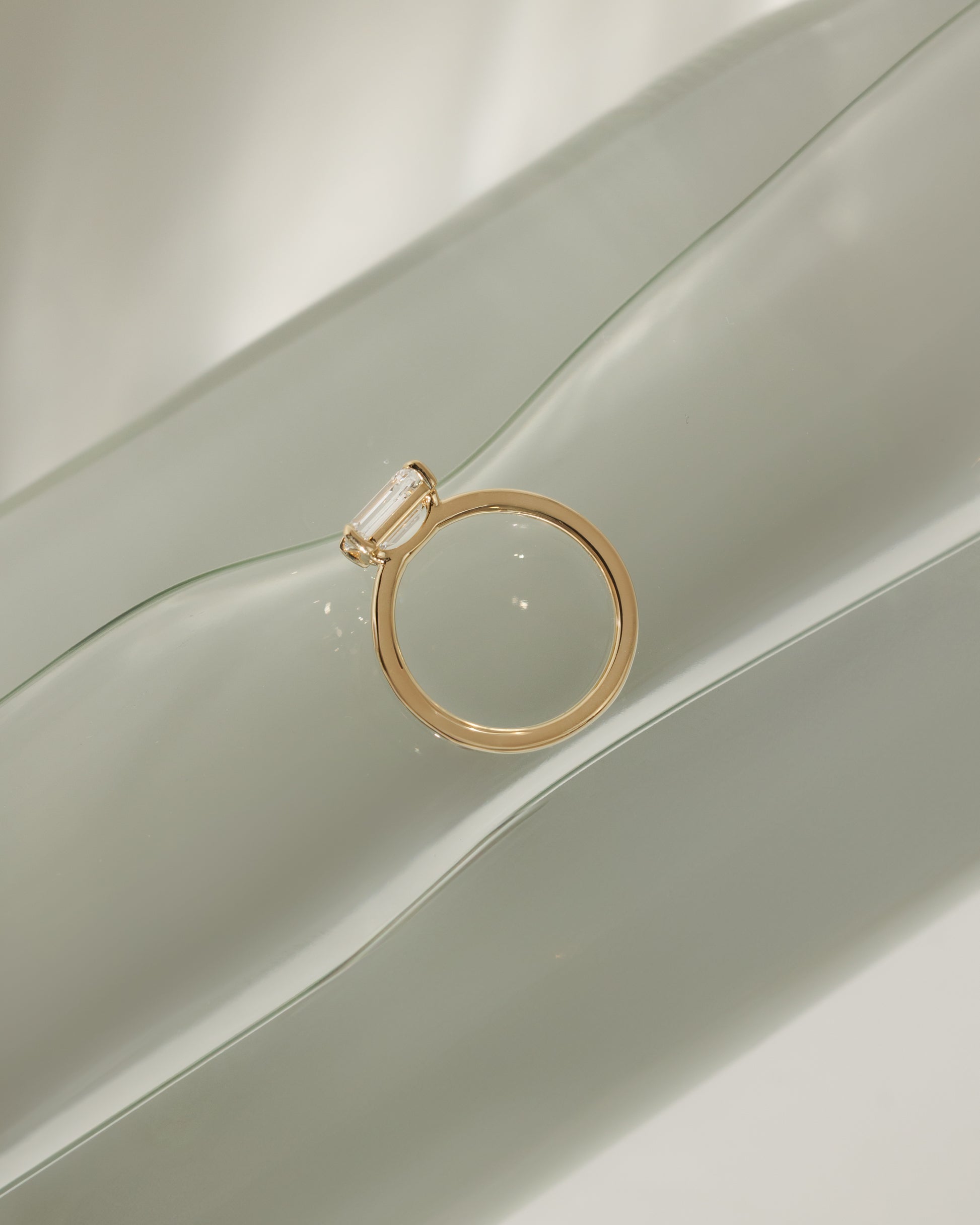 Evelyn - Emerald East West Claw Solitaire with Raised Basket Gallery Engagement Ring - Platinum - Lifestyle
