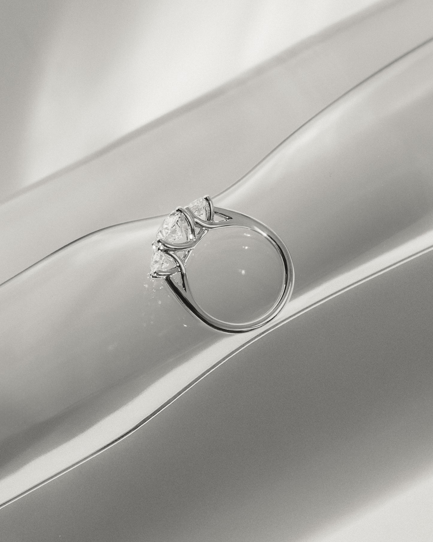 Grace - Oval Claw Trilogy with Round Side Stones, Open Trellis Gallery and Tapered Band Engagement Ring - Platinum - Lifestyle