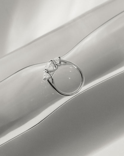 Grace - Oval Claw Trilogy with Round Side Stones, Open Trellis Gallery and Tapered Band Engagement Ring - Platinum