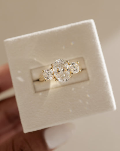 Grace - Oval Claw Trilogy with Round Side Stones, Open Trellis Gallery and Tapered Band Engagement Ring - Platinum