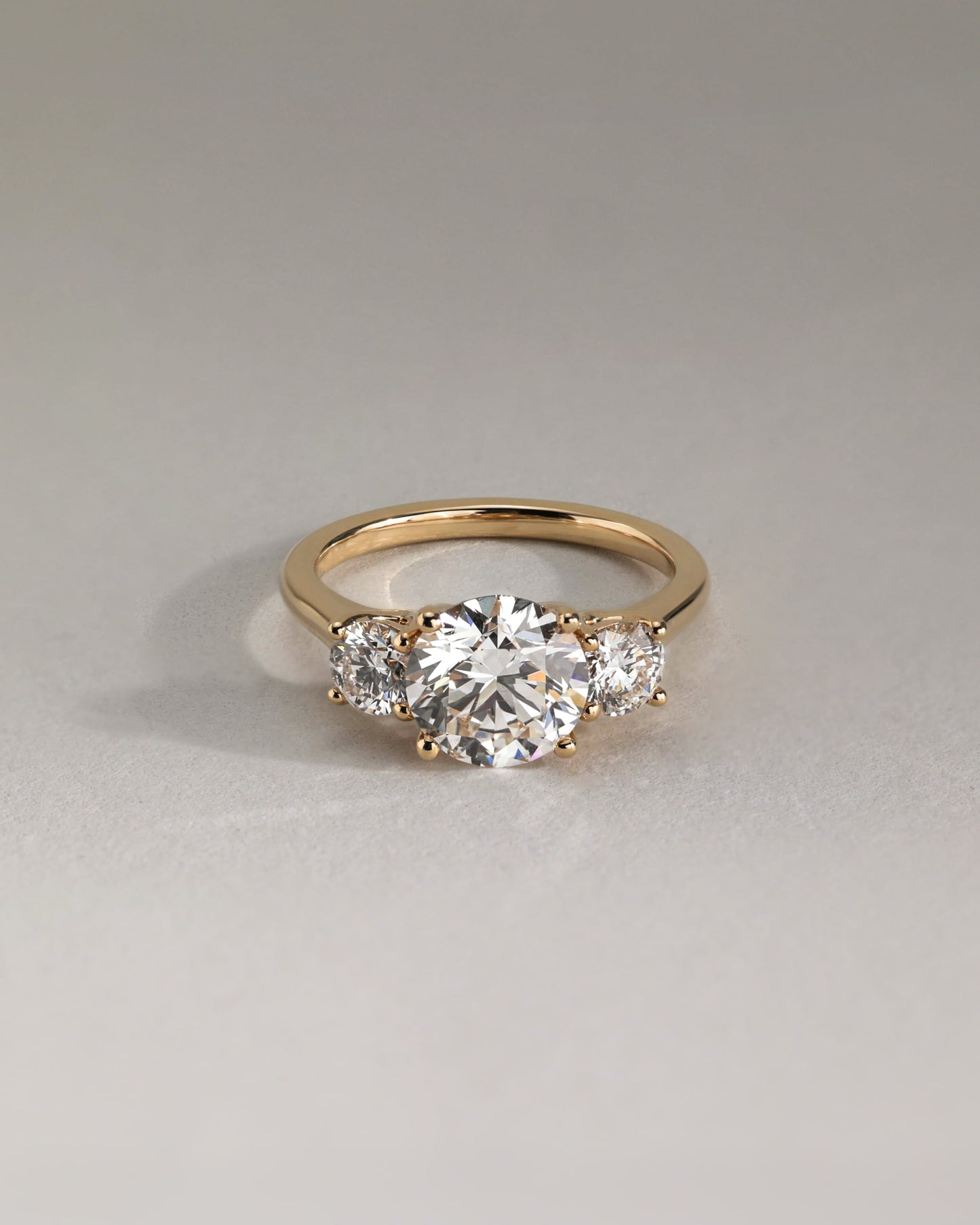 Octavia - Round Claw Trilogy with Round Side Stones and Trellis Gallery Engagement Ring - White Gold