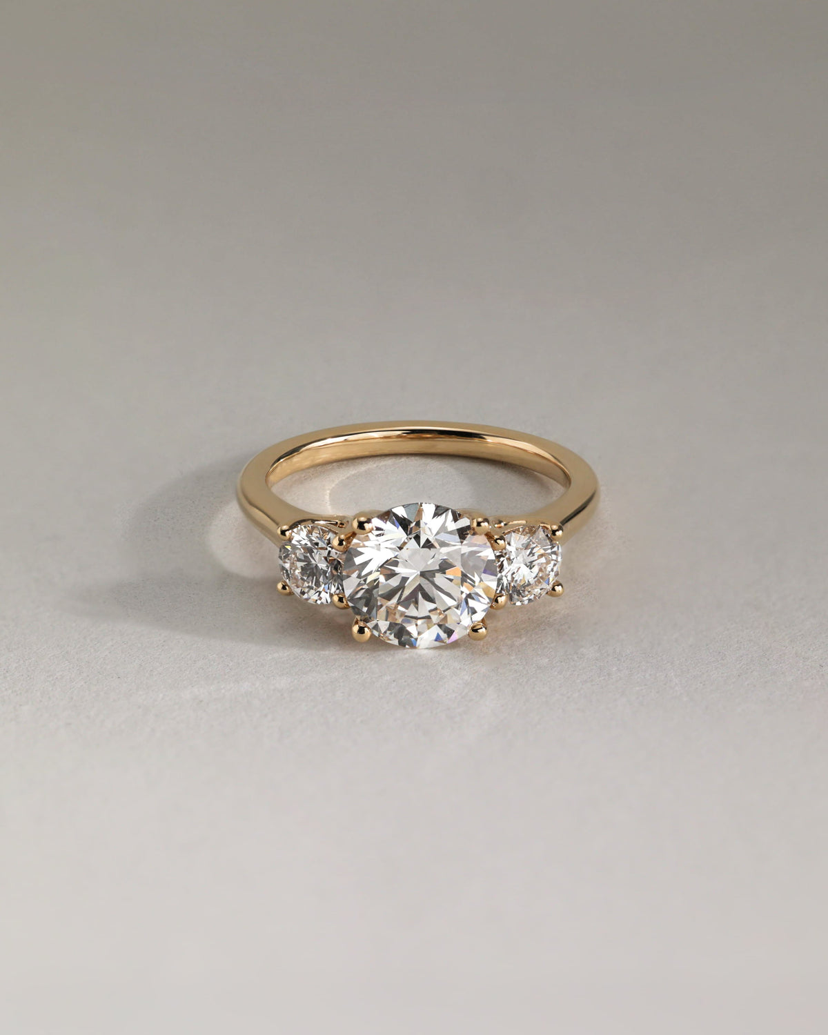 Octavia - Round Claw Trilogy with Round Side Stones and Trellis Gallery Engagement Ring - Rose Gold