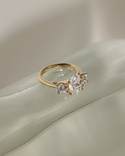 Grace - Oval Claw Trilogy with Round Side Stones, Open Trellis Gallery and Tapered Band Engagement Ring - Rose Gold