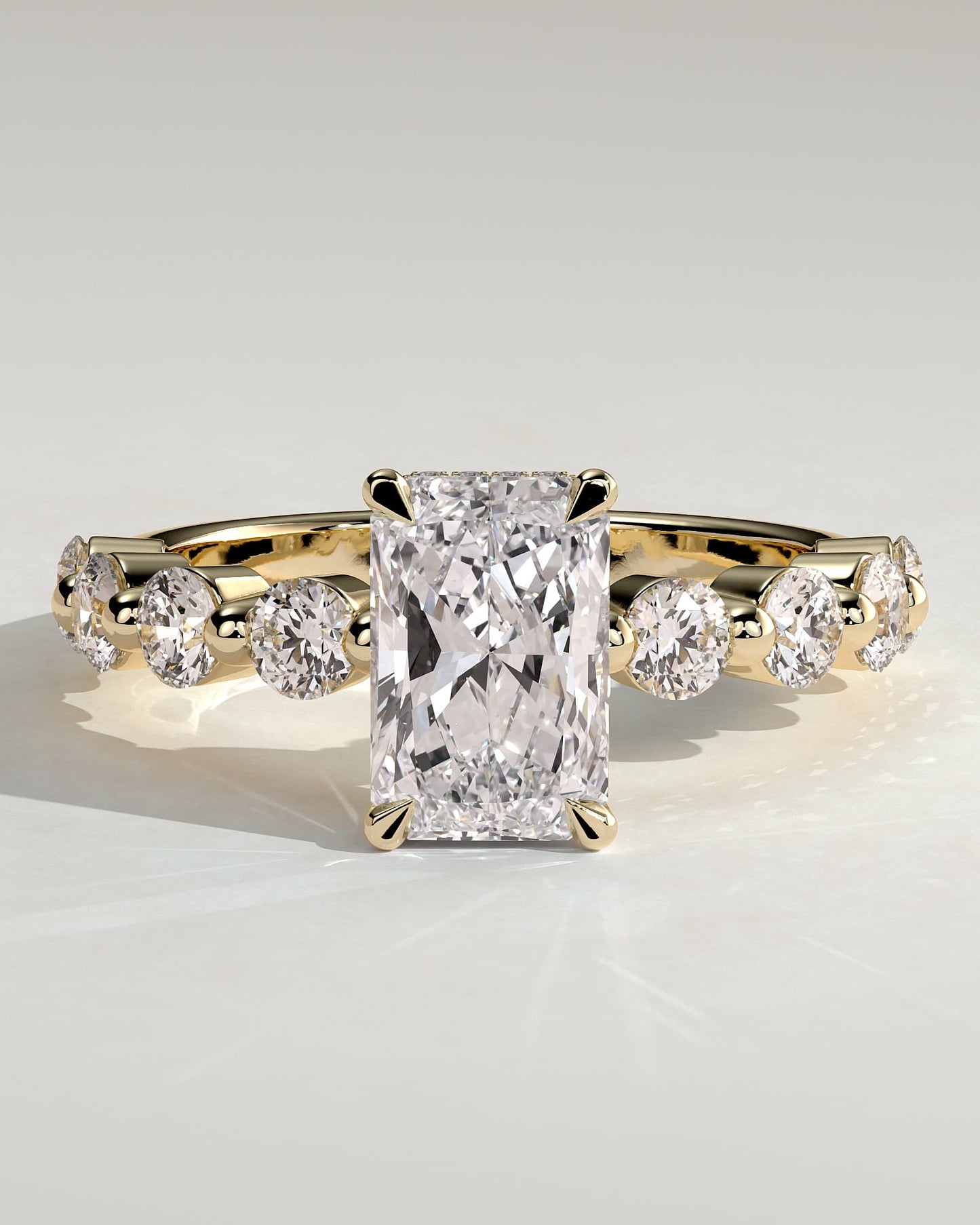 Josephine - Radiant Claw Solitaire with Round Accent Stones and Wrap Around Hidden Halo Engagement Ring - Yellow Gold