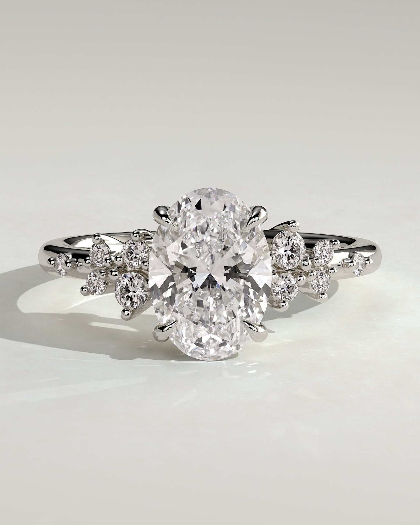Bella - Oval Claw Solitaire with Clustered Round Shoulder Stones Engagement Ring - White Gold