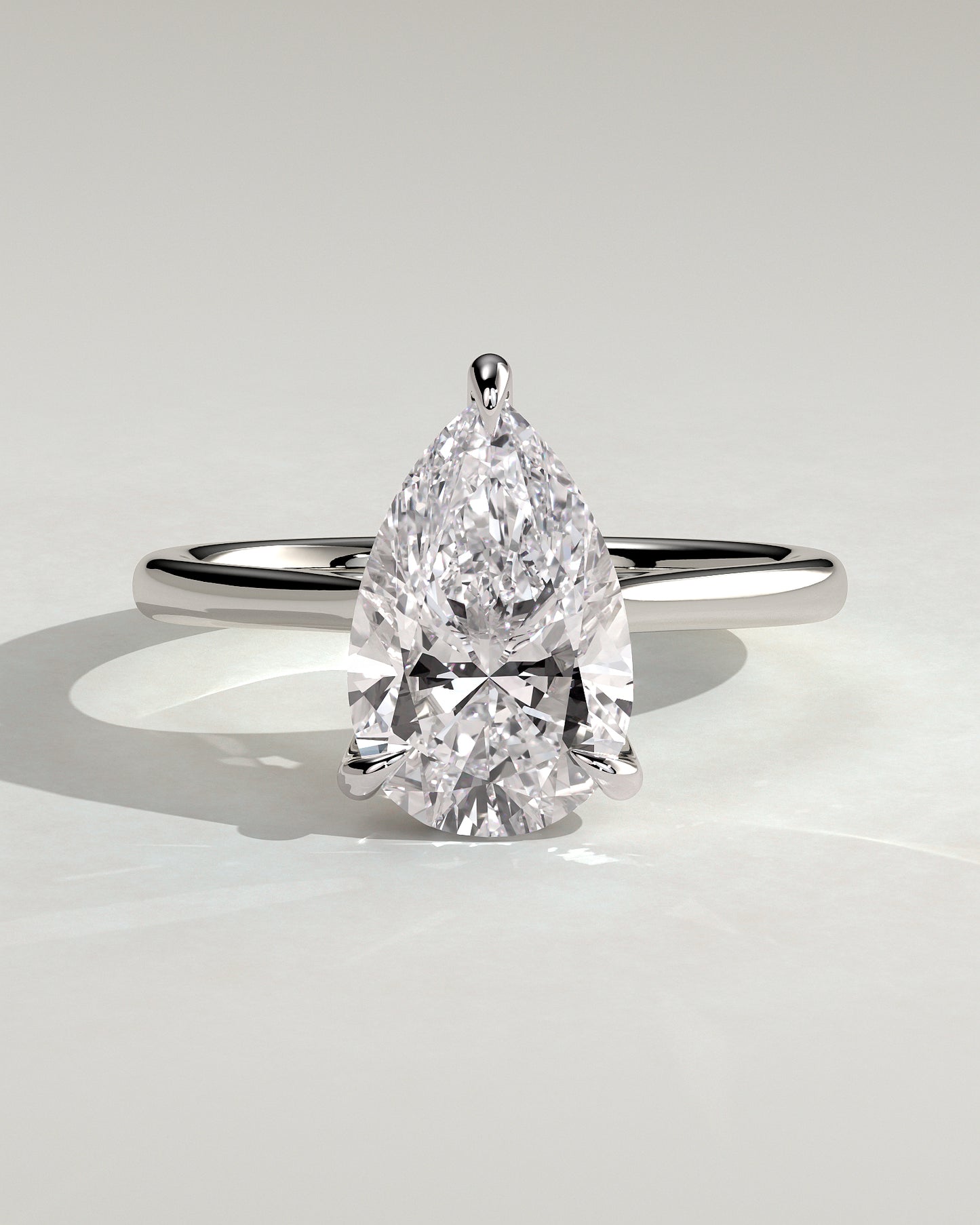 Courtney - Pear Claw Solitaire with Hidden Halo, Tapered Band and Cathedral High Setting Engagement Ring - White Gold