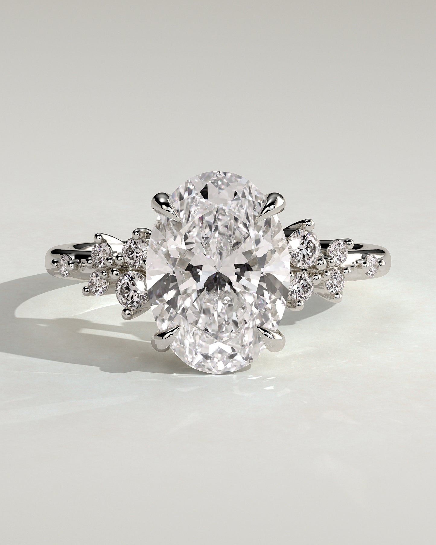 Bella - Oval Claw Solitaire with Clustered Round Shoulder Stones Engagement Ring - Platinum