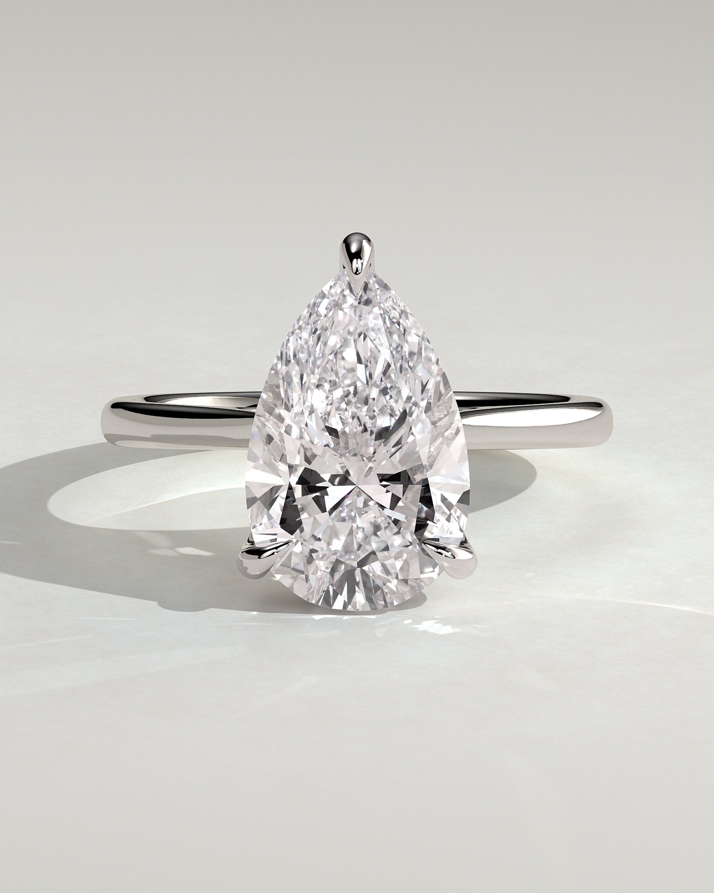 Courtney - Pear Claw Solitaire with Hidden Halo, Tapered Band and Cathedral High Setting Engagement Ring - White Gold