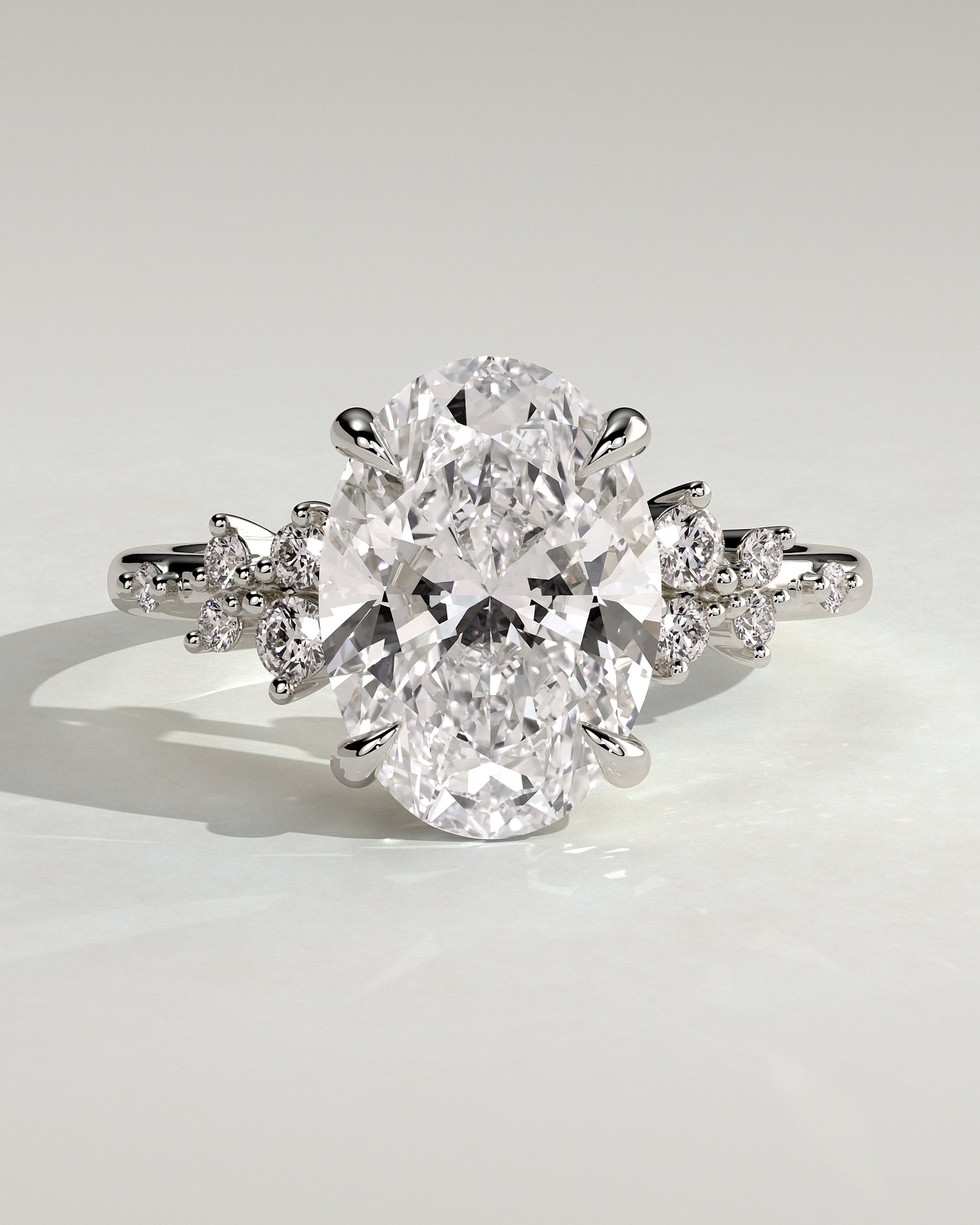 Bella - Oval Claw Solitaire with Clustered Round Shoulder Stones Engagement Ring - Platinum