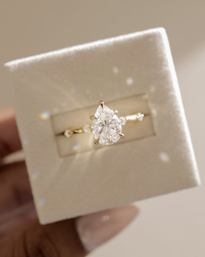 Amora - Pear Claw Solitaire with 6 Spaced Round Accent Stones and Hidden Halo Engagement Ring - Yellow Gold