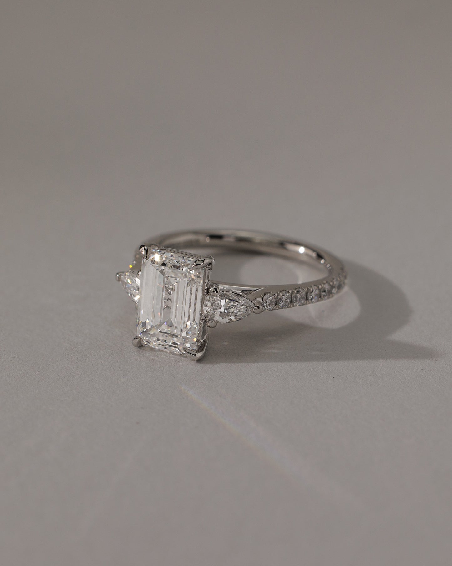 Autumn - Emerald Claw Trilogy with Pear Side Stones and Pave Band Engagement Ring - Rose Two-Tone - Lifestyle