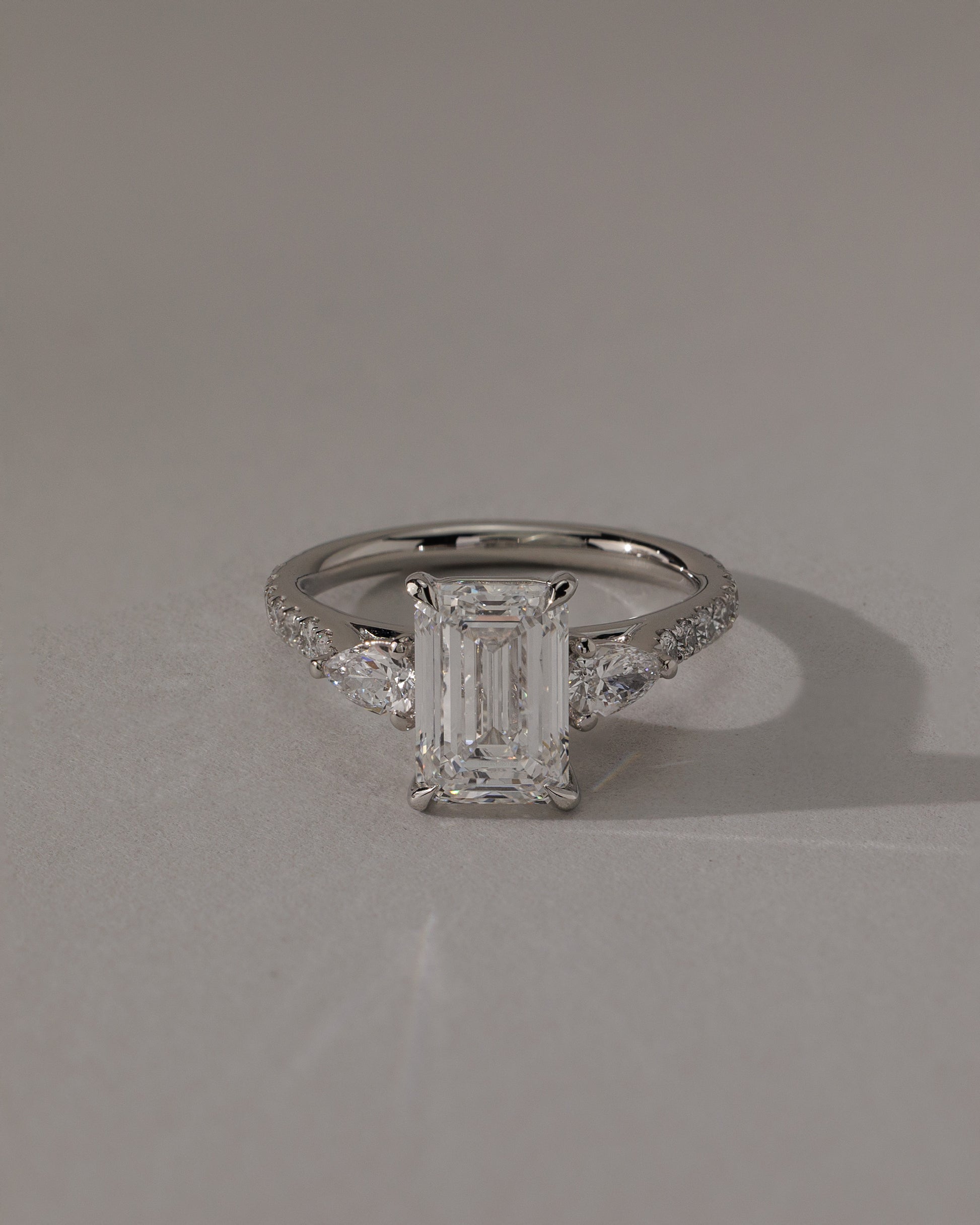 Autumn - Emerald Claw Trilogy with Pear Side Stones and Pave Band Engagement Ring - Rose Two-Tone - Lifestyle