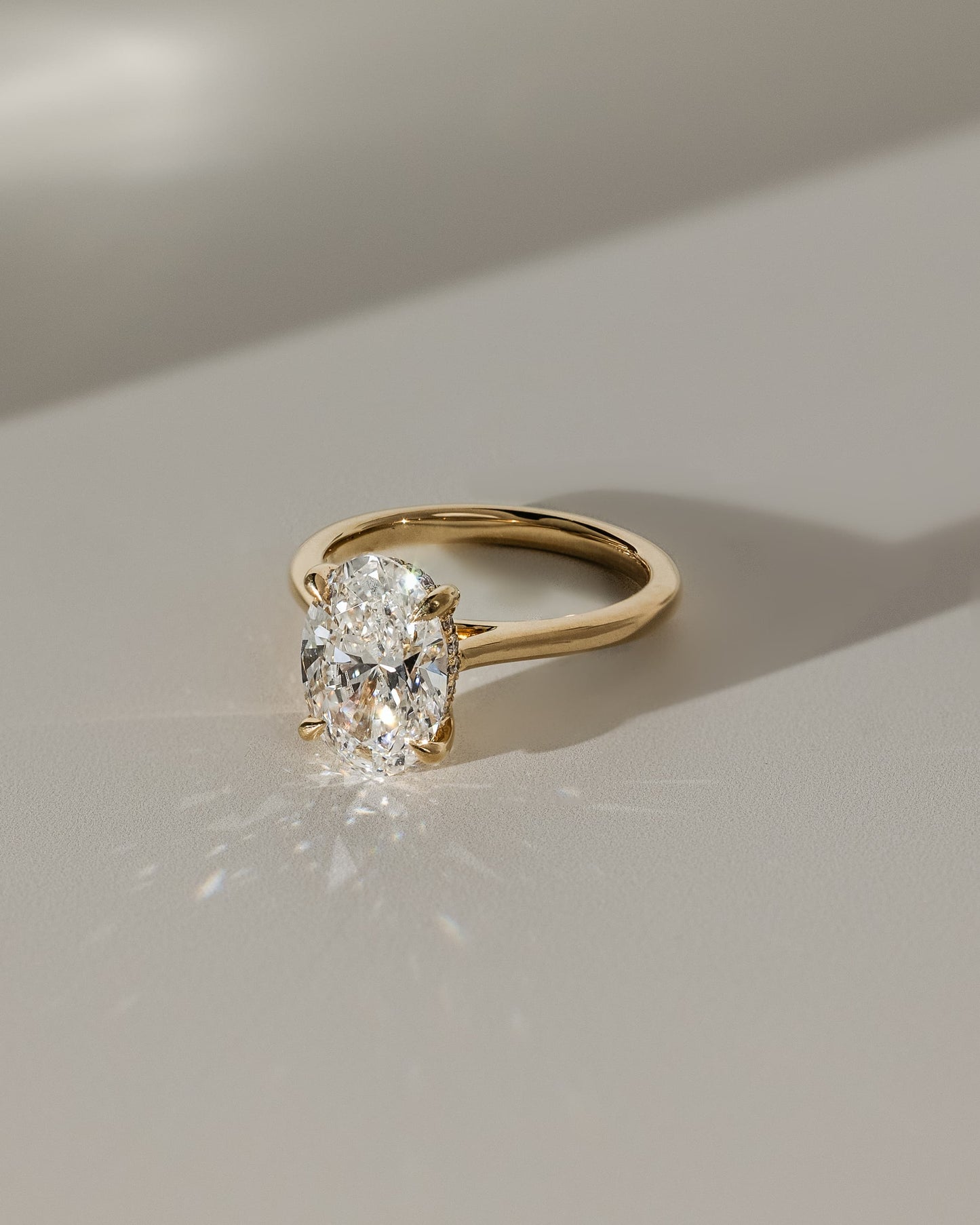 Bethany - Oval Claw Solitaire with Hidden Halo, Tapered Band and Cathedral High Setting Engagement Ring - White Gold