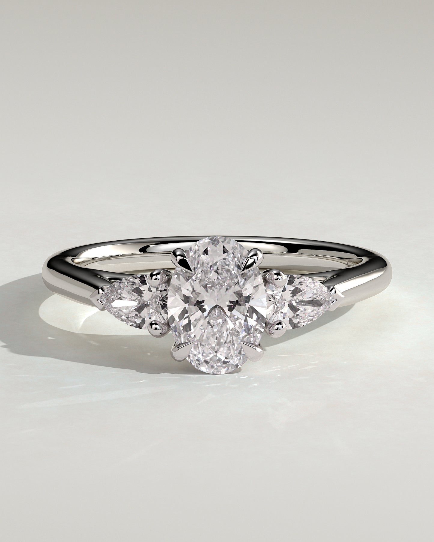 Alexia - Oval Claw Trilogy with Pear Side Stones and Cathedral Setting Engagement Ring - Platinum