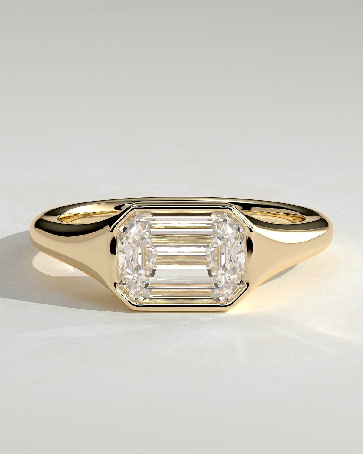 Montanah - Emerald East West Bezel Solitaire with Signet Band Engagement Ring - Yellow Gold