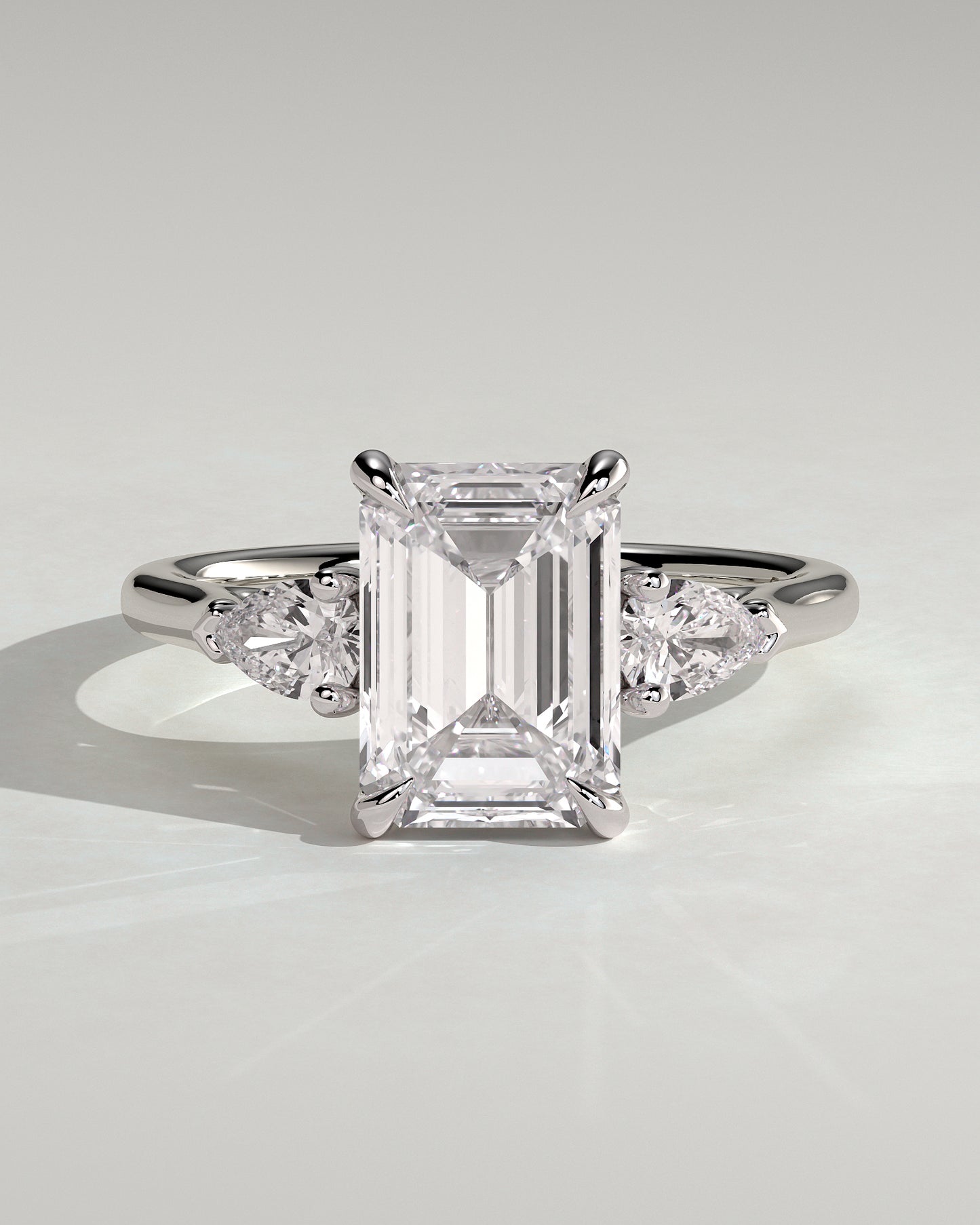 Davina - Emerald Claw Trilogy with Pear Side Stones and Cathedral Setting Engagement Ring - Platinum