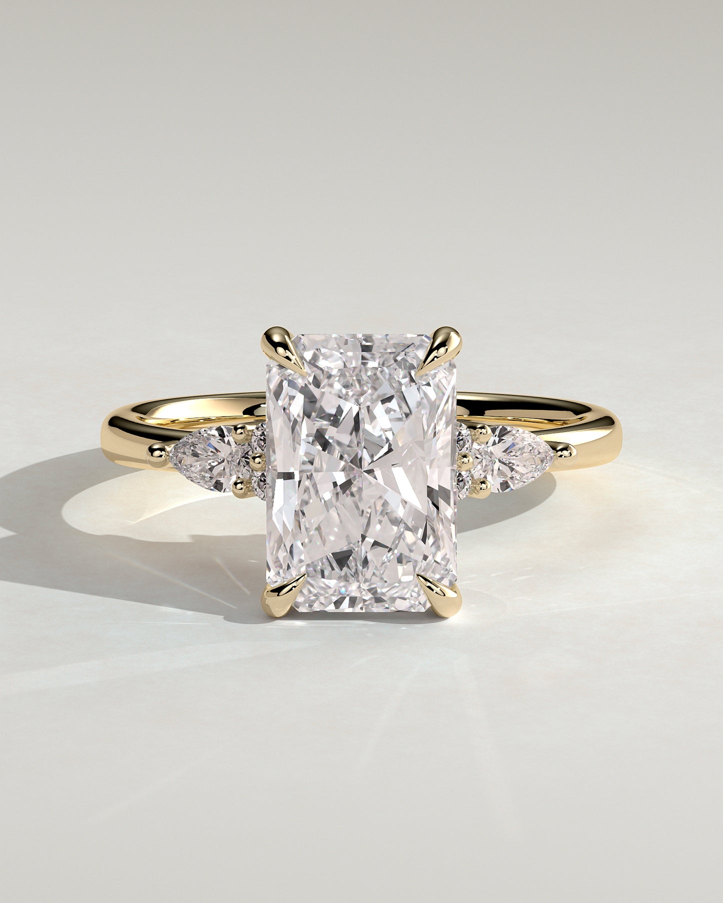Heidi - Radiant Claw Solitaire with Pear Accents and Round Shoulder Stones Engagement Ring - Yellow Gold