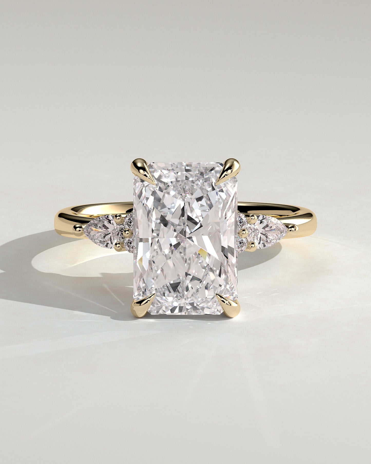 Heidi - Radiant Claw Solitaire with Pear Accents and Round Shoulder Stones Engagement Ring - Yellow Gold