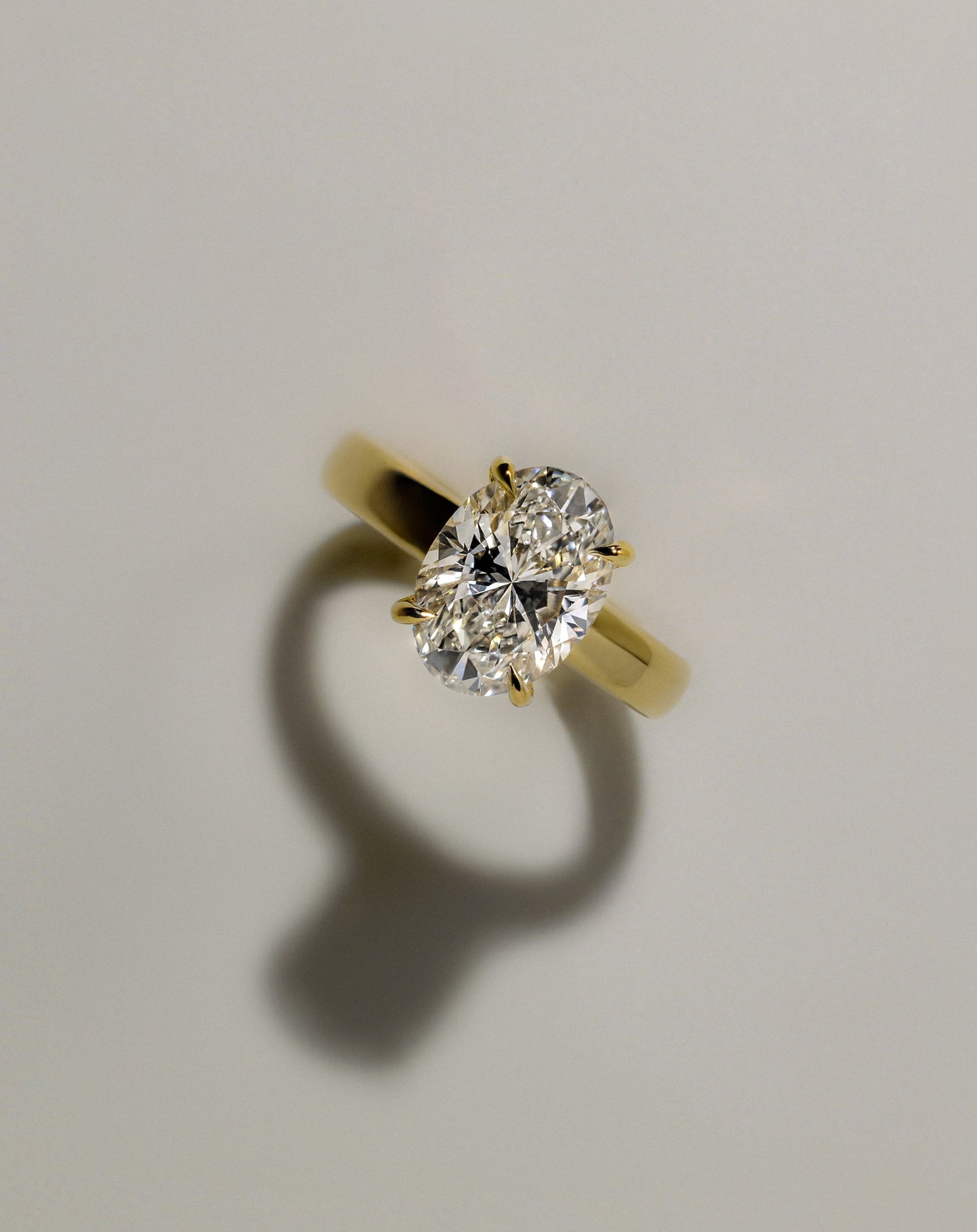 Bronte - Oval Claw Solitaire with Cigar Band and Hidden Halo Engagement Ring - Yellow Gold