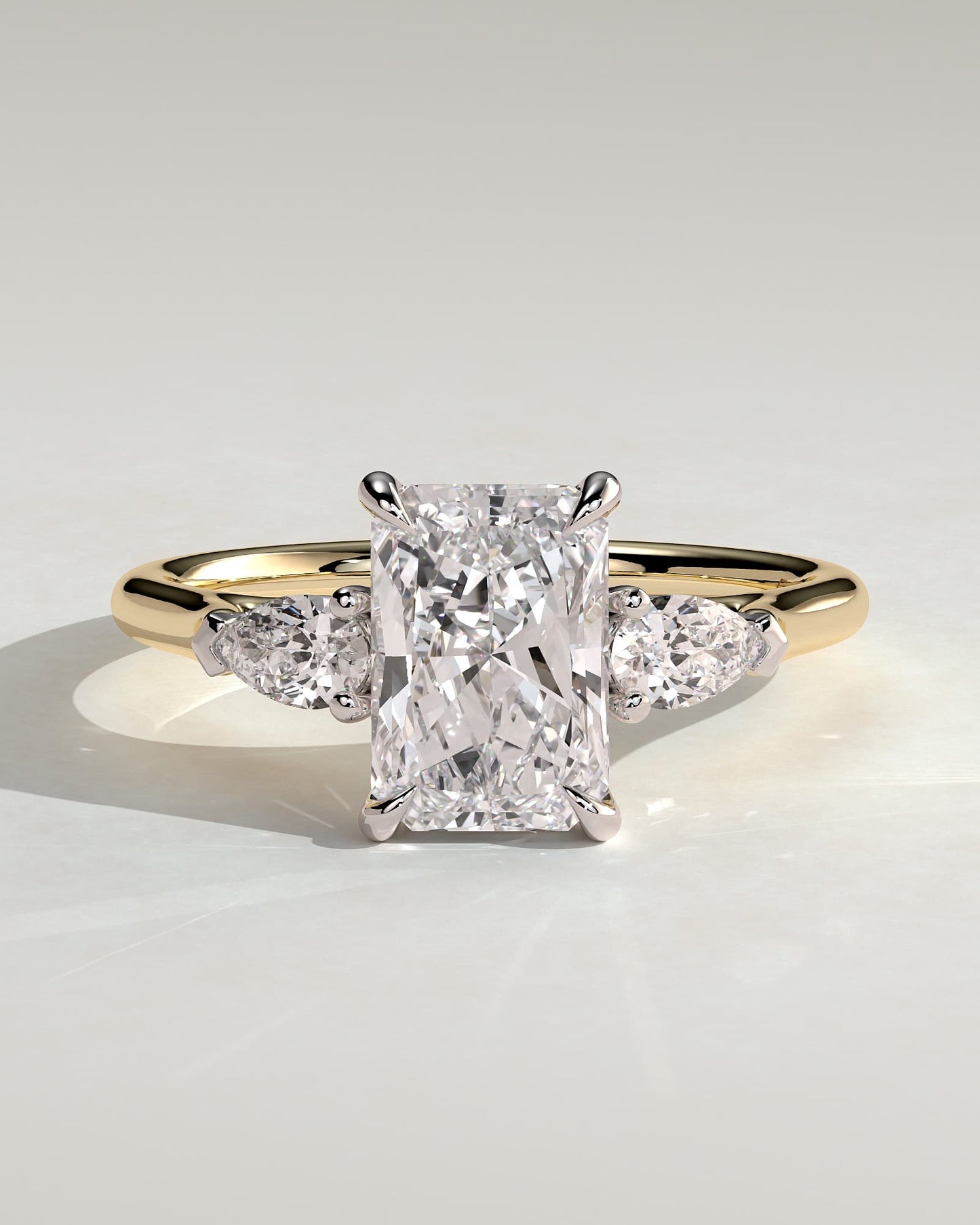 Jasmine - Radiant Claw Trilogy with Pear Side Stones and Cathedral Setting Engagement Ring - Yellow Two-Tone