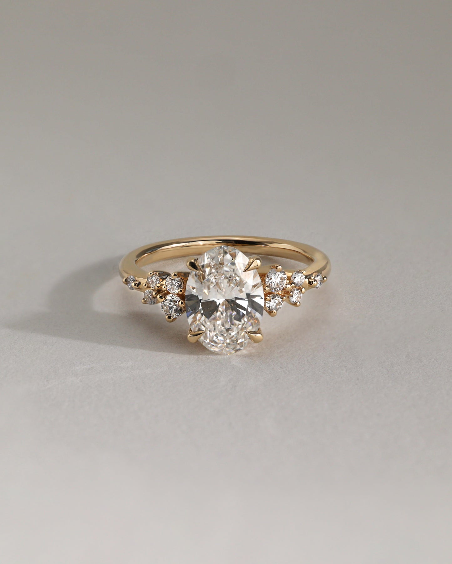 Bella - Oval Claw Solitaire with Clustered Round Shoulder Stones Engagement Ring - Platinum - Lifestyle