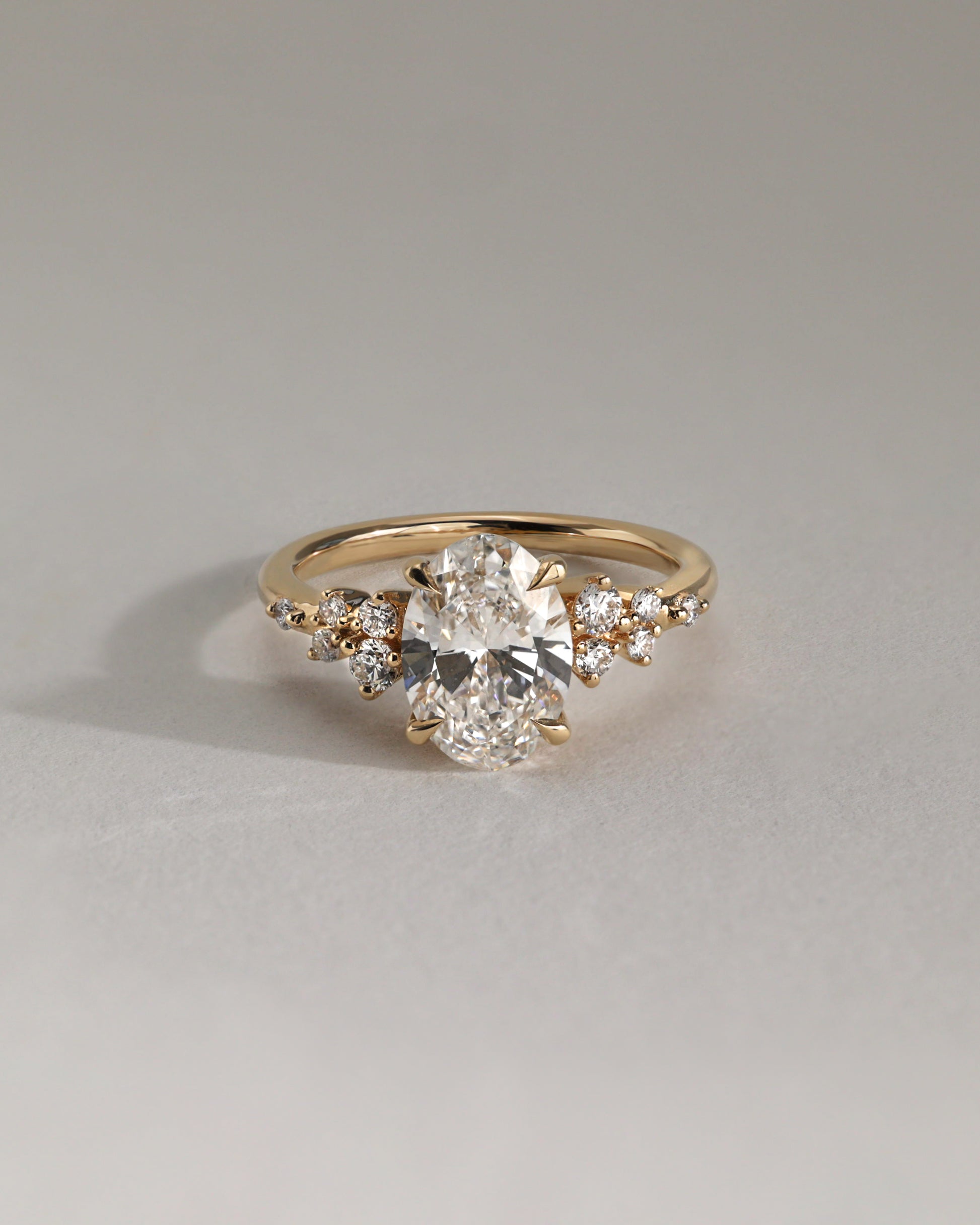 Bella - Oval Claw Solitaire with Clustered Round Shoulder Stones Engagement Ring - Platinum - Lifestyle