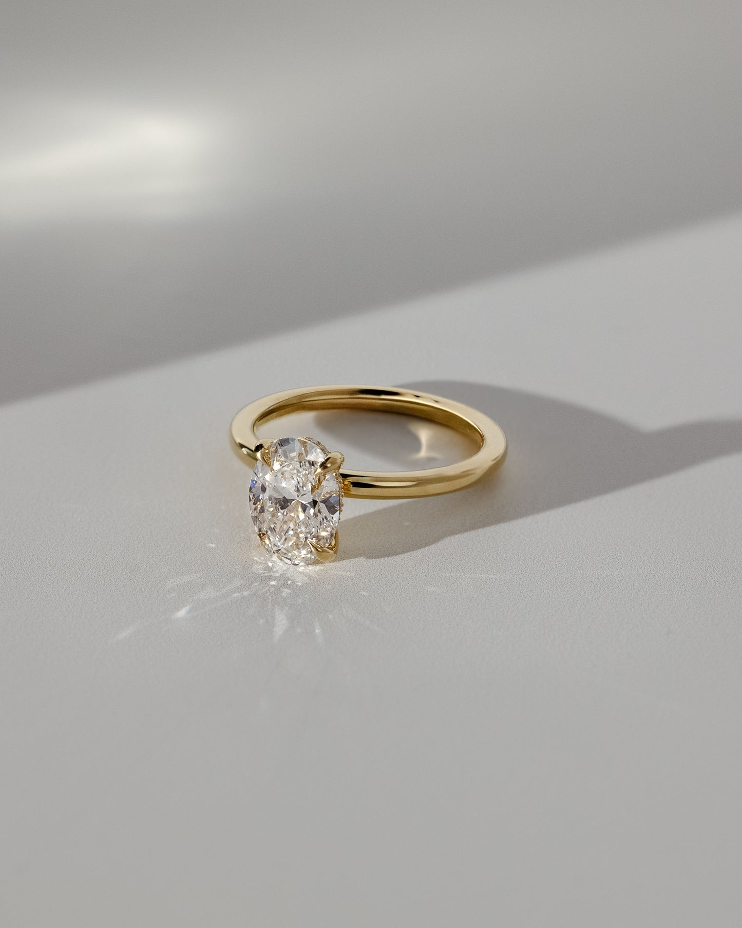 Emma - Classic Oval Claw Solitaire with Hidden Halo Engagement Ring - White Gold / Platinum - Lifestyle