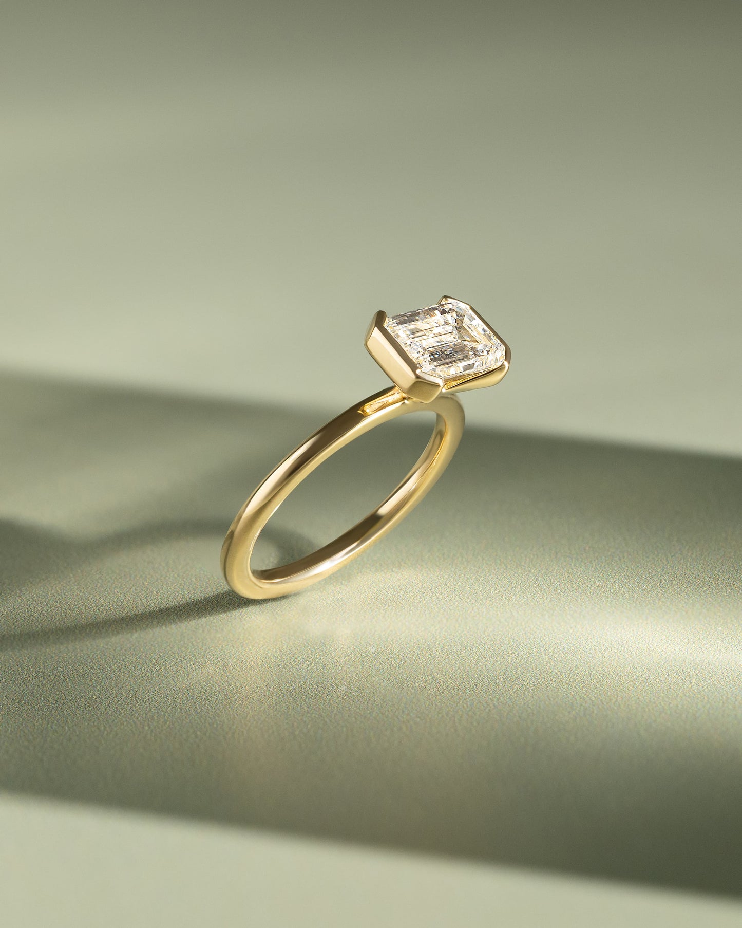 Jodie - Emerald East West Half Bezel Solitaire Engagement Ring - Yellow Gold