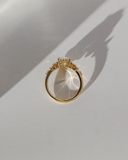 Bella - Oval Claw Solitaire with Clustered Round Shoulder Stones Engagement Ring - Yellow Gold
