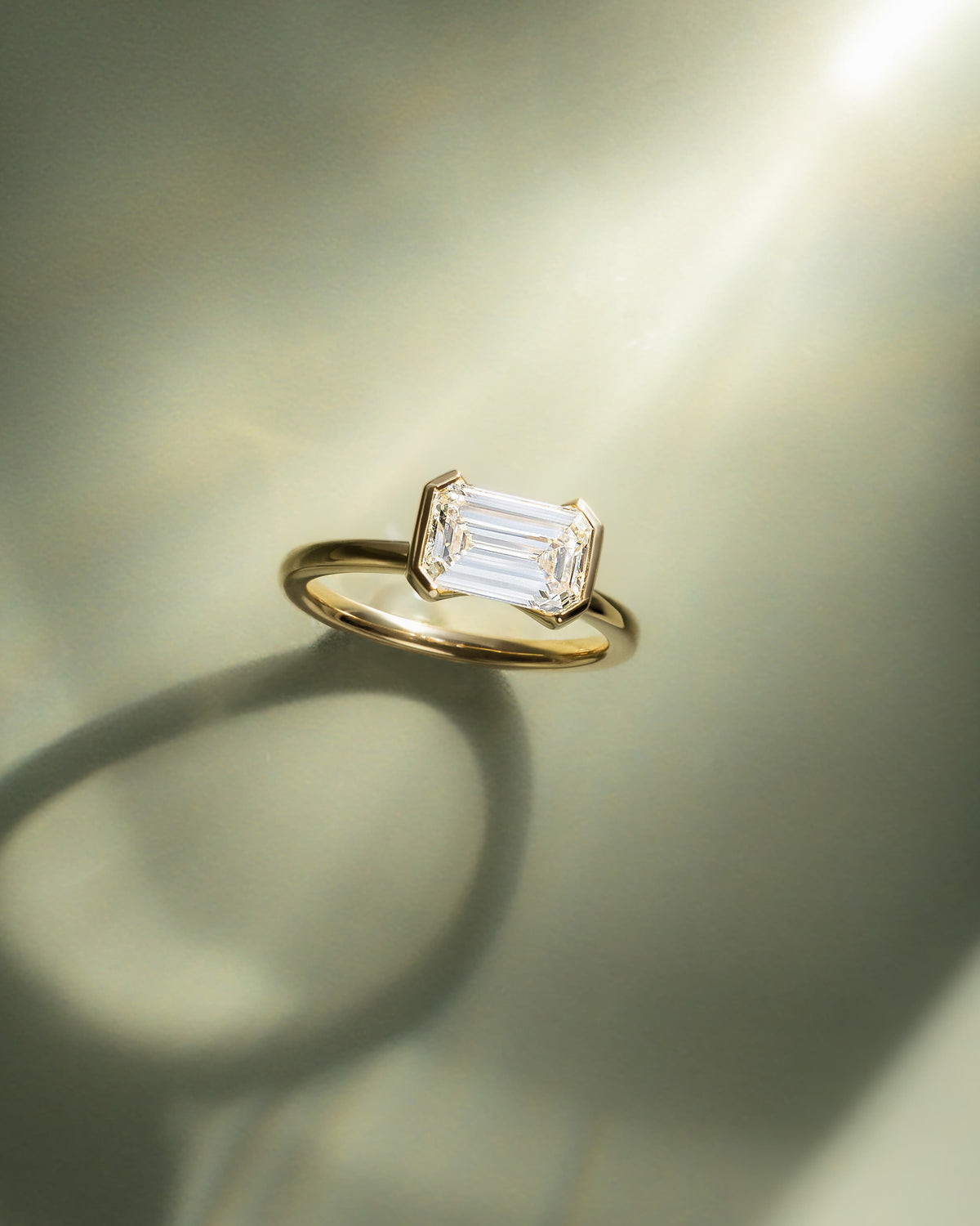 Jodie - Emerald East West Half Bezel Solitaire Engagement Ring - Yellow Gold