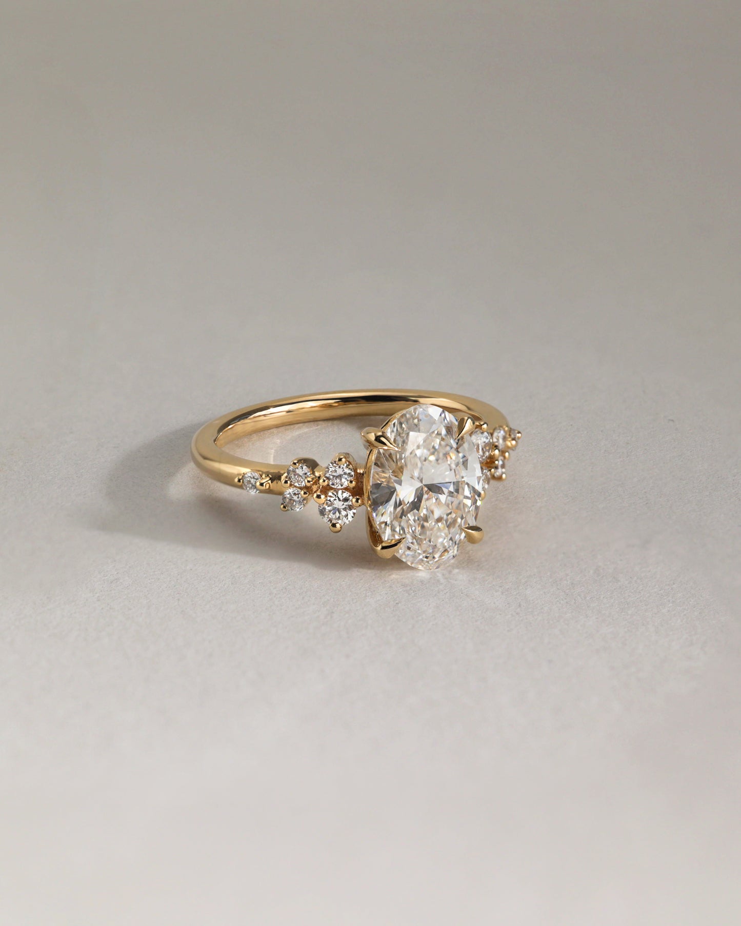 Bella - Oval Claw Solitaire with Clustered Round Shoulder Stones Engagement Ring - Platinum - Lifestyle