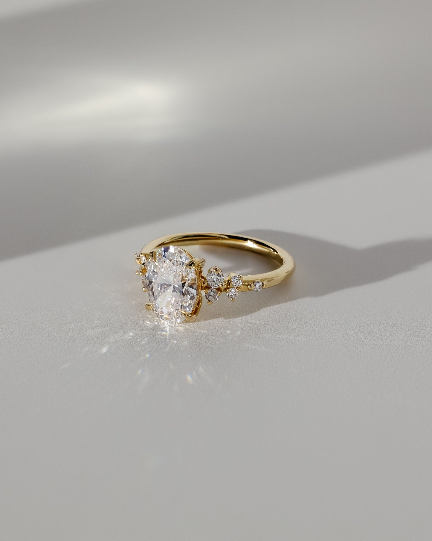 Bella - Oval Claw Solitaire with Clustered Round Shoulder Stones Engagement Ring - Platinum - Lifestyle