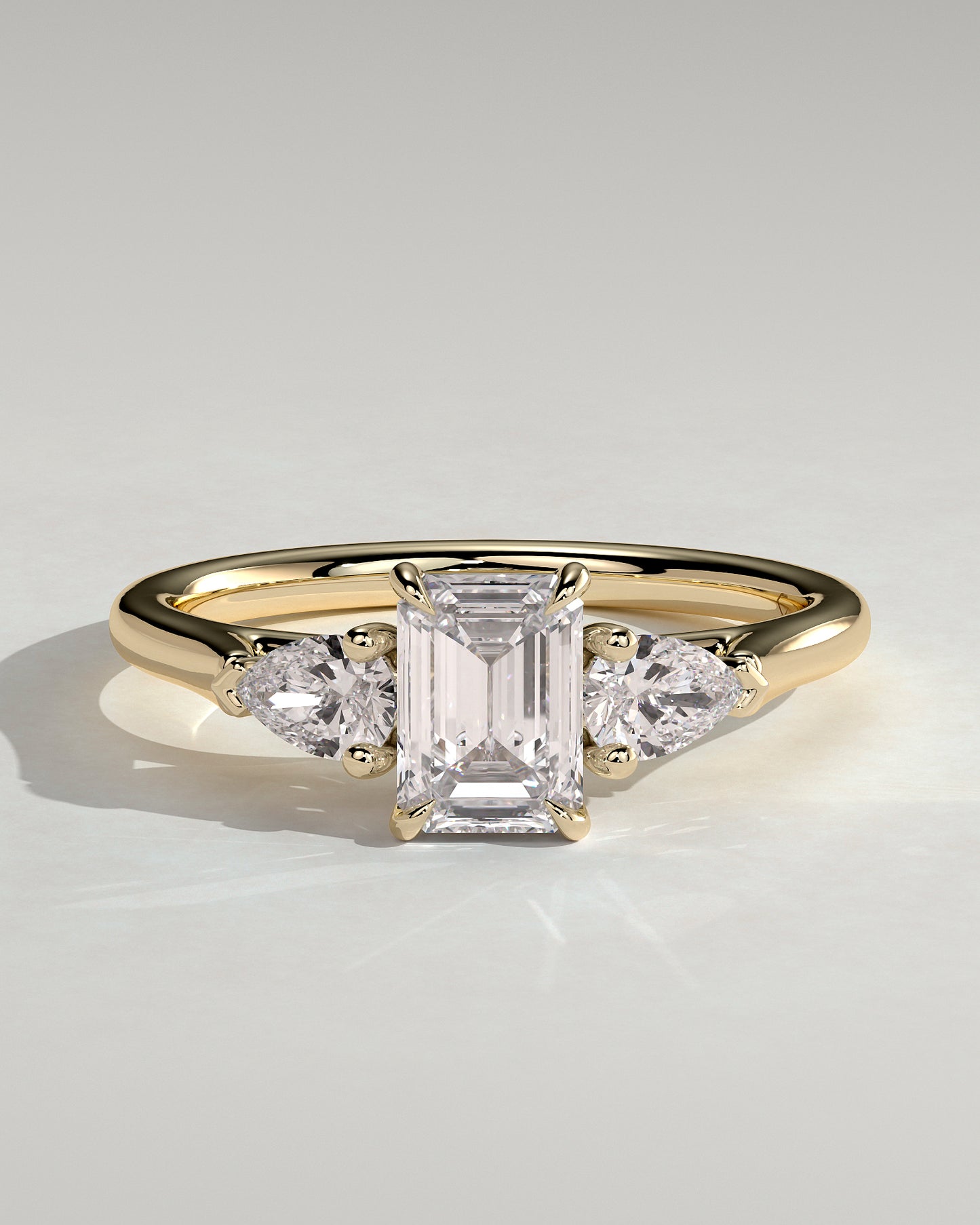 Davina - Emerald Claw Trilogy with Pear Side Stones and Cathedral Setting Engagement Ring - Yellow Gold
